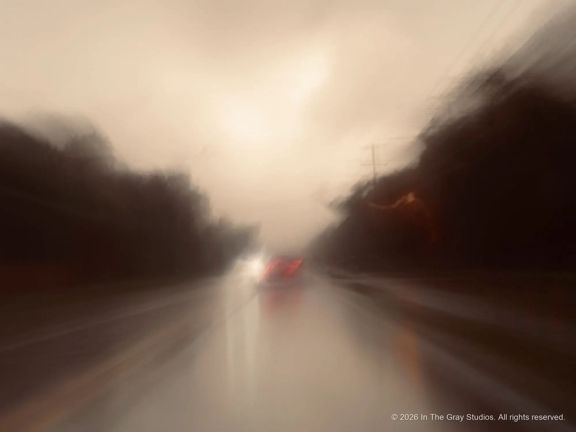 Headlights smeared across a windshield in a downpour