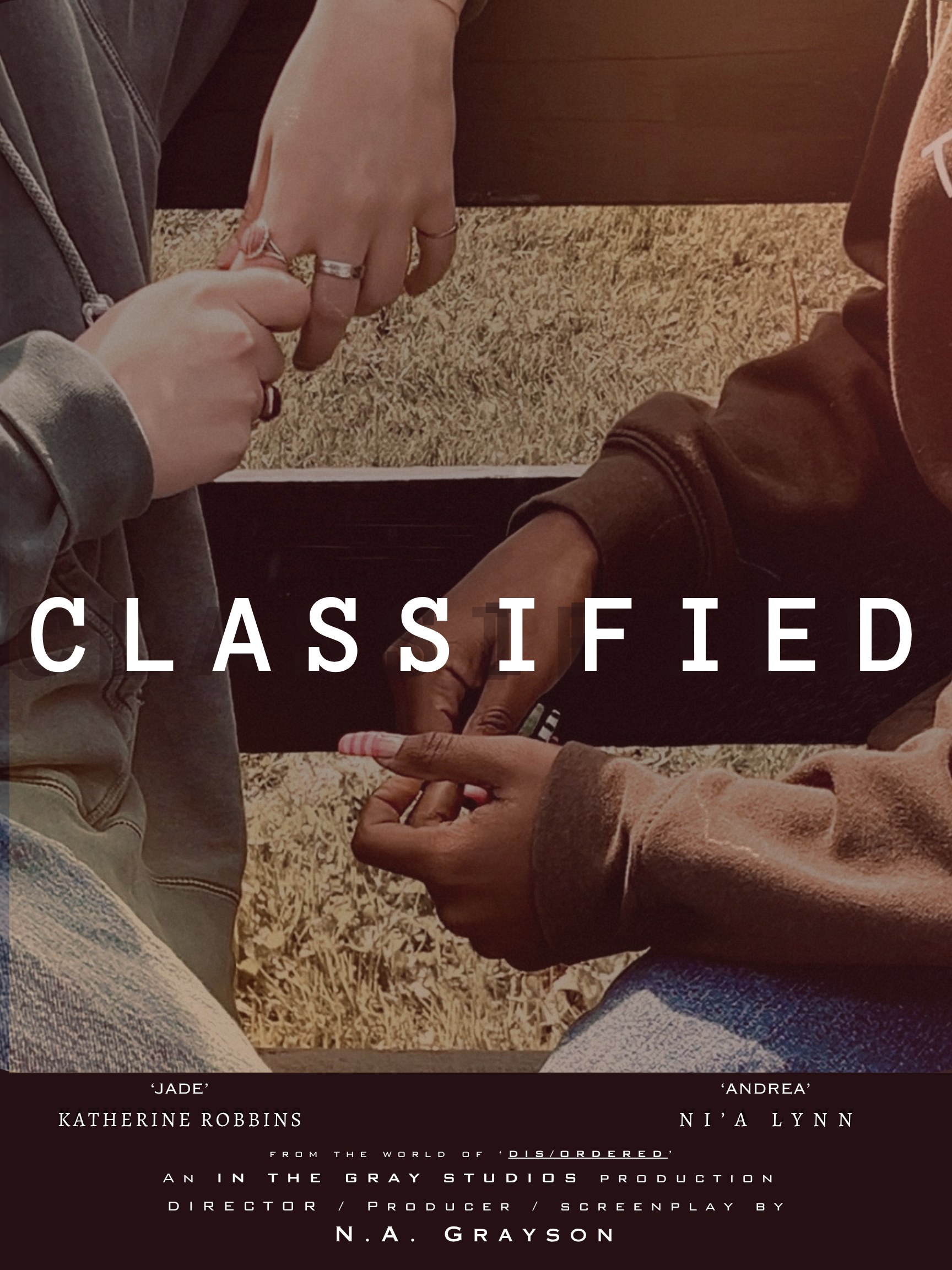 CLASSIFIED poster: two pairs of hands reaching toward each other, credited to 'Jade' Katherine Robbins and 'Andrea' Ni'a Lynn, from the world of DIS/ORDERED
